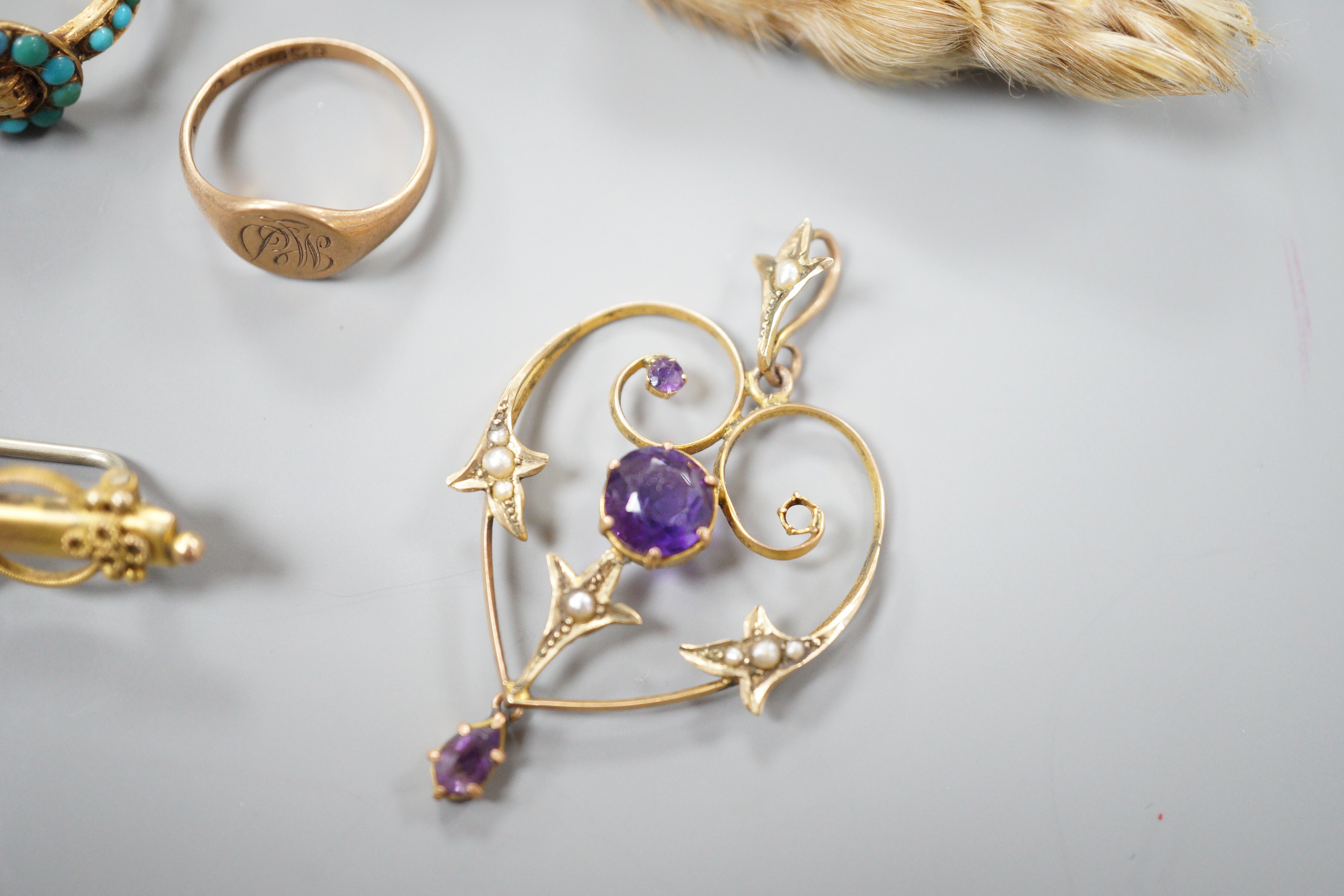 A small collection of jewellery to include an Edwardian amethyst and seed pearl pendant, two rings including Victorian yellow metal and turquoise 'buckle' ring, a bar brooch and a paw brooch.